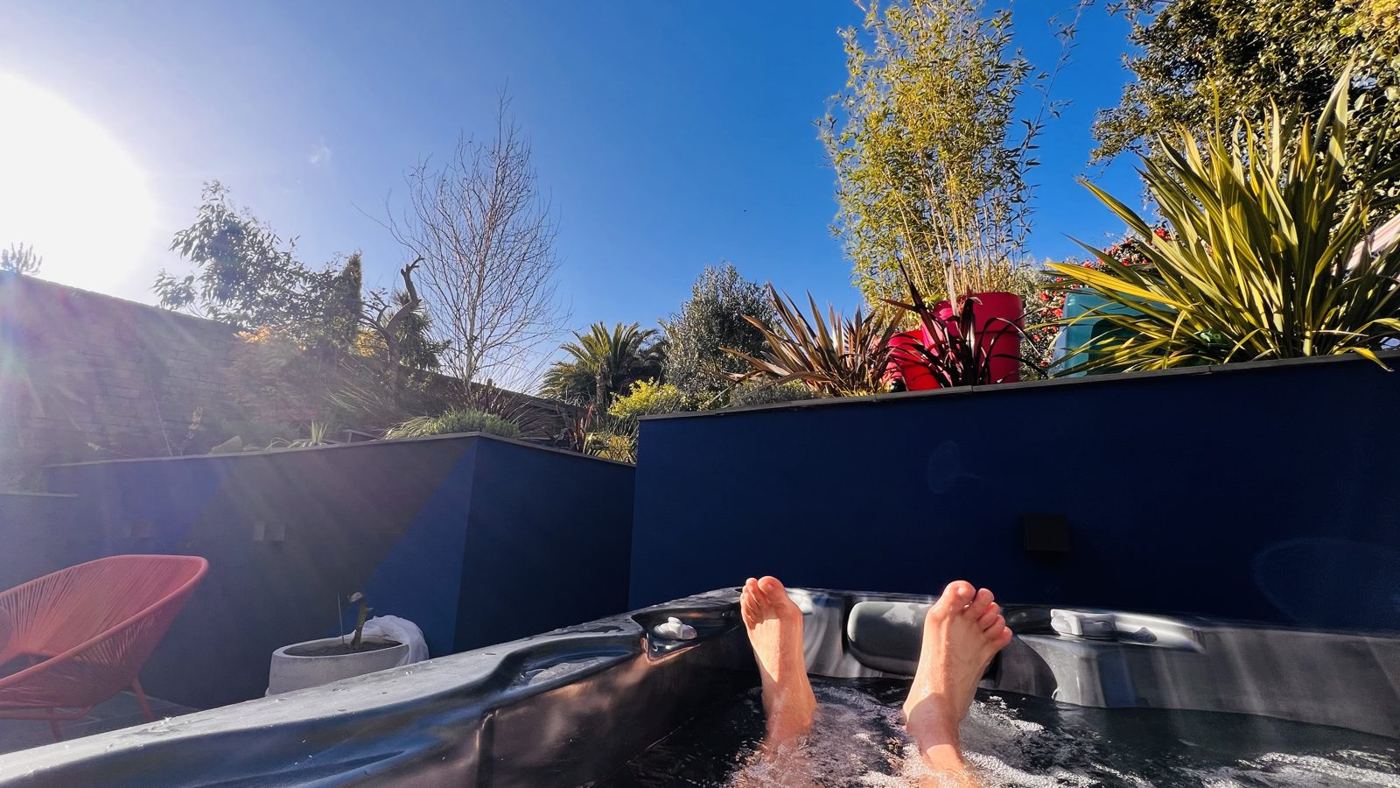 Relaxing in the hot tub in the studio garden on a sunny day